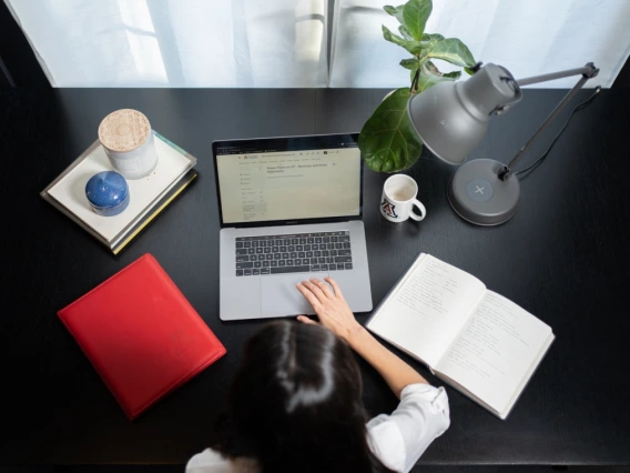 Photo of a student on a laptop at her desk