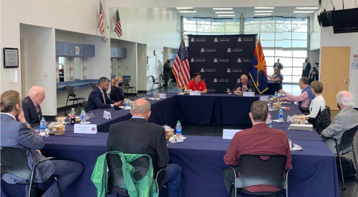 Photo of President Robbins speaking with Governor Doug Ducey at a roundtable