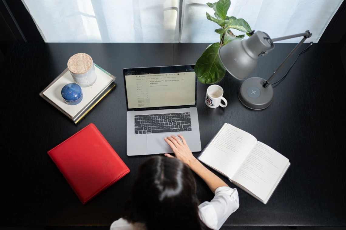 Photo of a student on a laptop at her desk