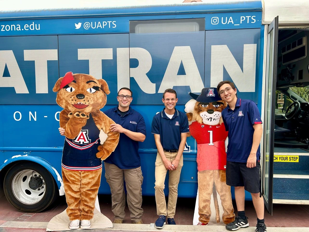 Dr. Xavi Segura, a UA Cares Ambassador from the School of Government and Public Policy, poses for a photo with GCR team members after bringing his department donations to be delivered to the Community Food Bank and Campus Pantry.