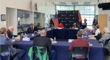 Photo of President Robbins speaking with Governor Doug Ducey at a roundtable